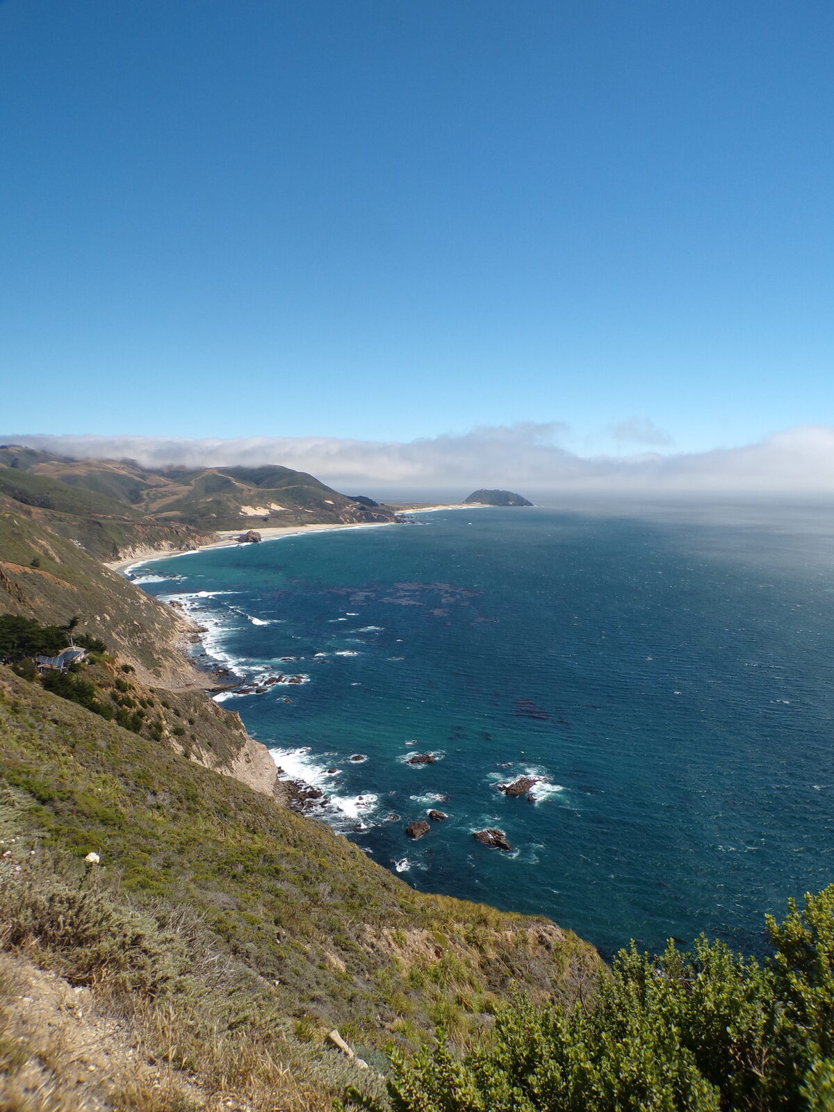 Marine fog layer spilling over coastal hills along Highway 1